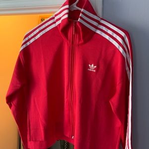 A pink/red Adidas crop sweater